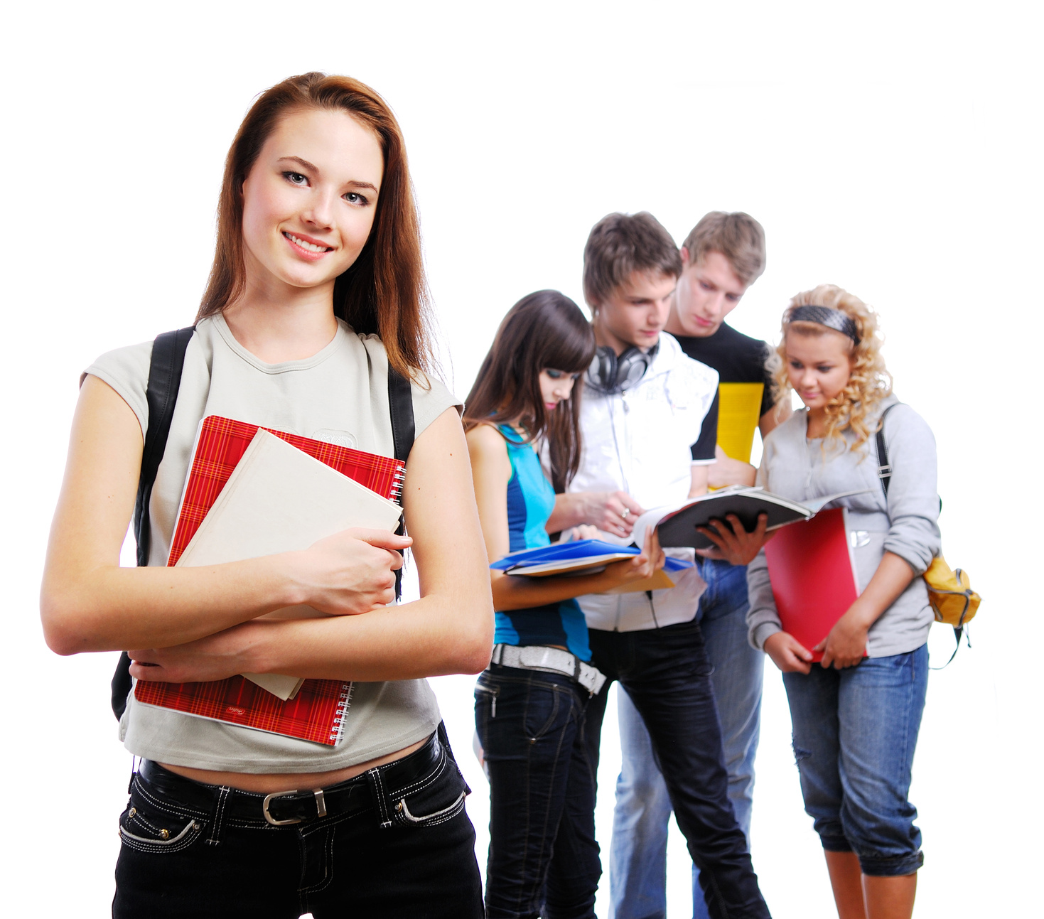 Graceful female student with books in hands looking at camera. On a background classmates